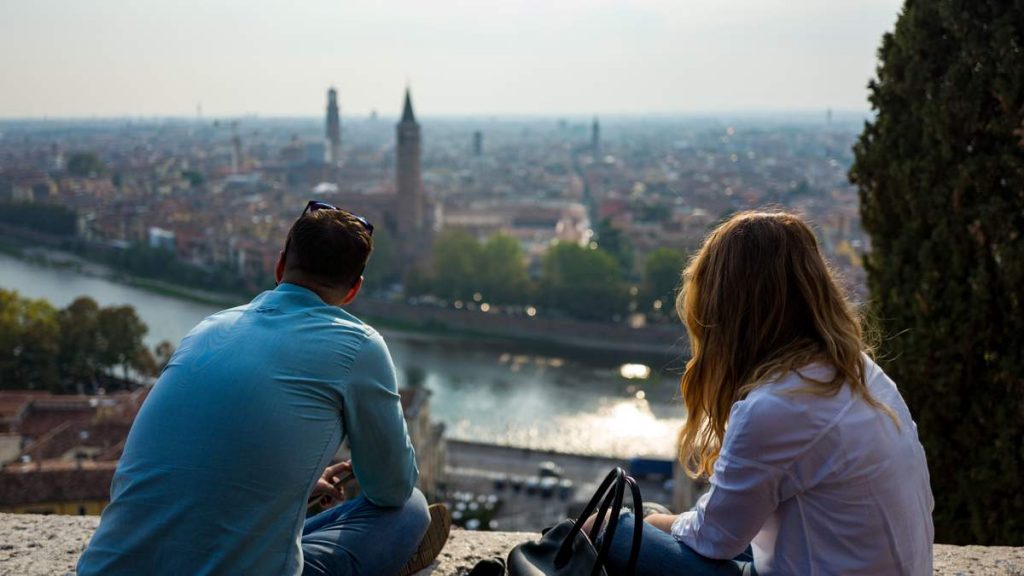 Casal desfrutando da bela vista de Verona, Itália.